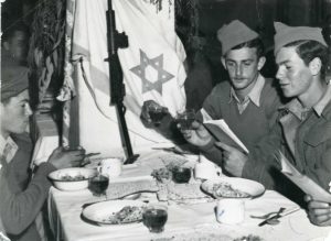 Every Seder that year in Jerusalem was as uplifting and joyous as it was tense and fearful. Hagana soldiers join the Seder between shifts  I Courtesy of the Central Zionist Archives, Jerusalem